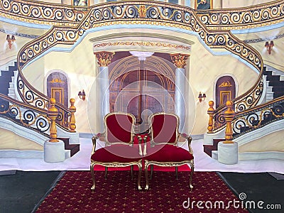 Two royal chairs under staircase background Stock Photo