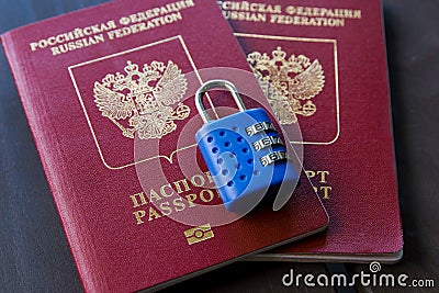 Two Russian passports locked to padlock. Symbol of anti-Russian sanctions Stock Photo