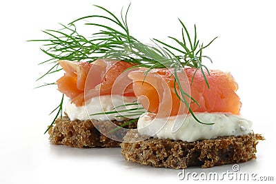 Two salmon canapes with fresh dill garnish, isolated on white b Stock Photo
