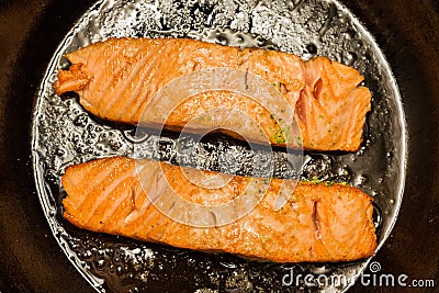 Two salmon steaks frying on the pan Stock Photo