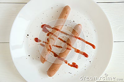 Two sausages white plate ketchup top view Stock Photo