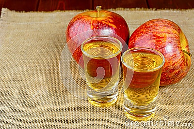 Two schnapps drinks and red apples Stock Photo