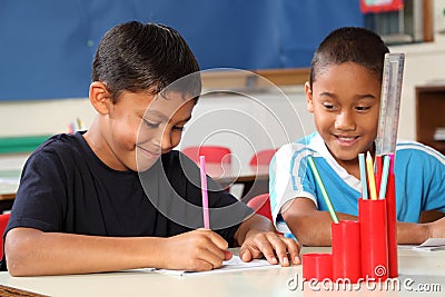 Two school boys enjoying their learning in class Stock Photo