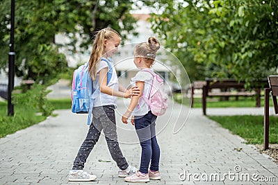 Two school friends met near the school. The concept of school, study, education, friendship, childhood. Stock Photo