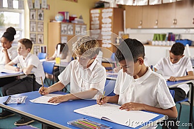 Two schoolboys working in a primary school class Stock Photo