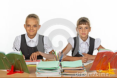 Two schoolgirls gaze intently and emotionlessly into the frame Stock Photo