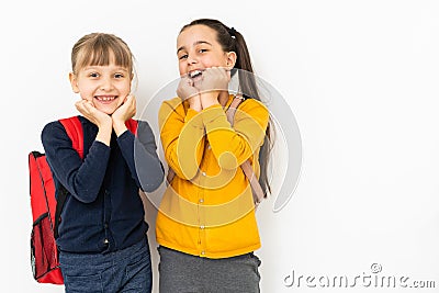 two schoolgirls show emotions. isolated on white background Stock Photo