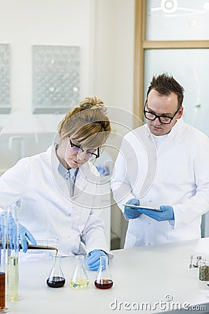 Two scientists working with CBD and CBDa oil Stock Photo