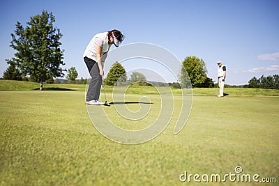 Two senior golf player on green. Stock Photo