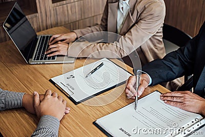 Two senior manager reading a resume during a job interview, Employer interviewing to ask young male job seeker for recruitment ta Stock Photo