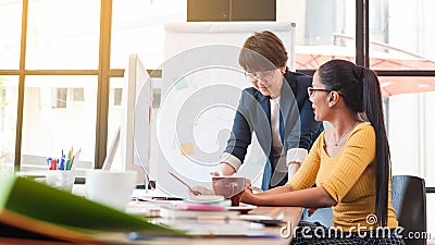 Two senior officer preparing paper work in office of creative work place, modern style of work, entrepreneur group brainstorming Stock Photo