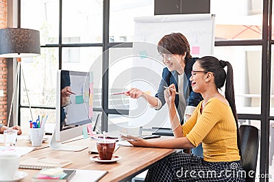 Two senior officer preparing paper work in office of creative work place, modern style of work, entrepreneur group brainstorming Stock Photo