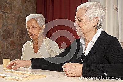 Two Senior Women Playing Dominoes Stock Photo