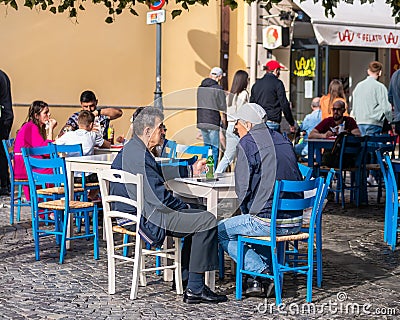 Two seniors people having a beer in the old town center, Bucharest Editorial Stock Photo