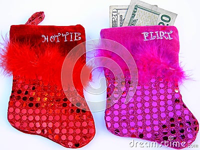 Two sequined and feathered flirt and hottie christmas stockings Stock Photo