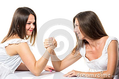 Two serious competetive women having arm wrestling fight, compete with each other. Stock Photo