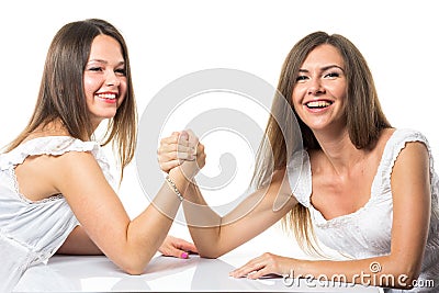 Two serious competetive women having arm wrestling fight, compete with each other. Stock Photo