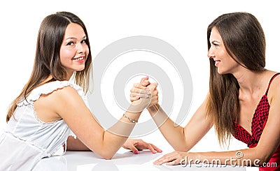Two serious competetive women having arm wrestling fight, compete with each other. Stock Photo