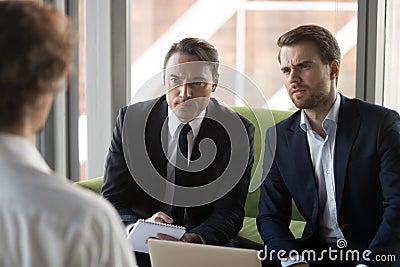 Two serious doubting hr managers listening to candidate in job interview Stock Photo