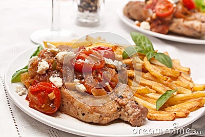 Two Servings of Pork Chops with Fries Stock Photo