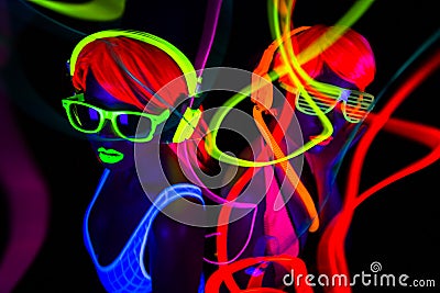 Two neon uv glow dancers Stock Photo