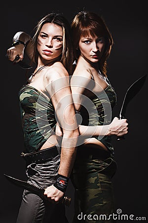 Two women with gun and dagger Stock Photo