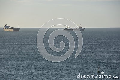 Two ships on the anchorage waiting to enter the port Stock Photo