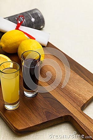 Two shots of lemon ginger and beetroot juice with lemons Stock Photo