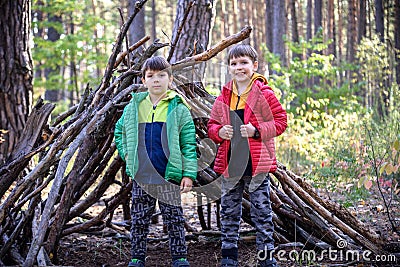 Two sibling brothers boys In the spring or autumn pine forest pl Stock Photo