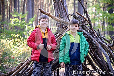 Two sibling brothers boys In the spring or autumn pine forest pl Stock Photo