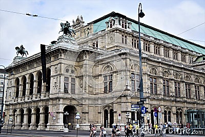 Two sides of a historic and important palace in Vienna. On the street, bicycle tourists and various pedestrians. Editorial Stock Photo