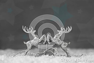 Two silver reindeer figurine on grey shabby chic christmas backg Stock Photo