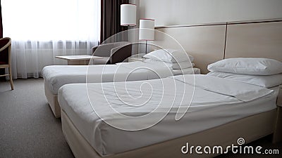 Two single beds in a cozy hotel room. Two elegant single beds in a spacious hotel room. A room with beds in a hotel Stock Photo