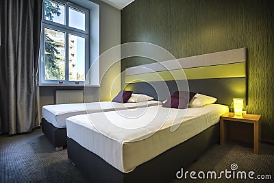 Two single beds in green hotel room Stock Photo