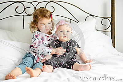 The Two sister baby in white bed at home Stock Photo