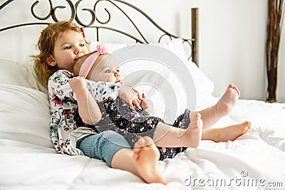 The Two sister baby in white bed at home Stock Photo