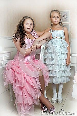 Two sisters in elegant dresses Stock Photo