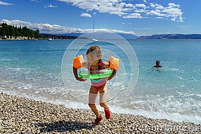 Two sisters playing games and swimming in the sea Stock Photo