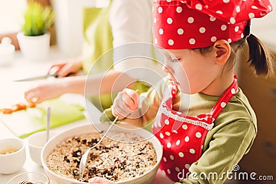 Two sisters preparing granola together. Stock Photo