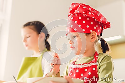 Two sisters preparing granola together. Stock Photo