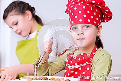 Two sisters preparing granola together Stock Photo