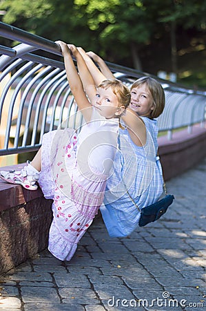 Two sisters on the railing Stock Photo
