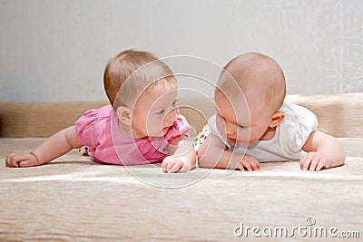 Two sisters, twin baby girls Stock Photo