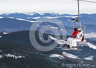 Two skiers on a platform on a background of high snow mountains Stock Photo