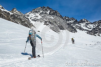 Two skiers skinning up slope near Snowbird Mine in Hatcher Pass area in the Talkeetna Mountains, Alaska Stock Photo