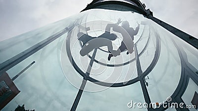 Two skydivers fly into wind tunnel. Extreme skydiving tandem in wind tunnel Stock Photo