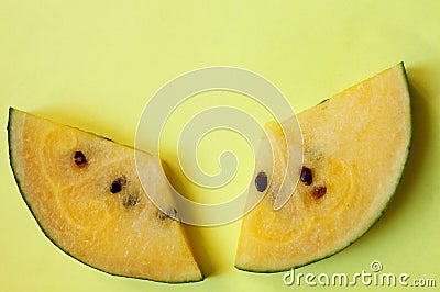 Two slices of yellow watermelon on a yellow background. Summer concert. A slice of watermelon. Delicious berry. Vitamins Stock Photo