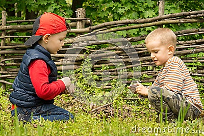 Two small boys having fun building a fire Stock Photo