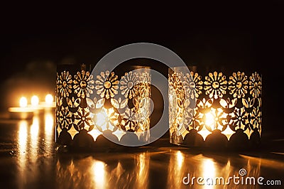 Two small burning candles on dark background Stock Photo