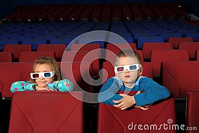 Two small children in 3D glasses watching a movie Stock Photo